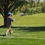 boy walking on lawn