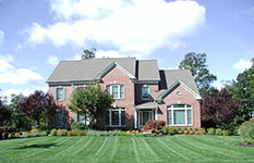 picture of a home with green grass in the early fall