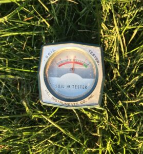 Picture of a pH meter in a lawn 