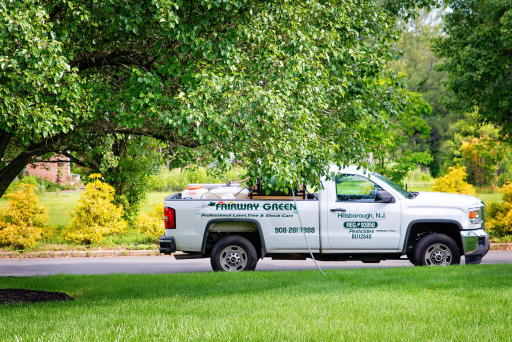 Fairway Green Inc. truck with green lawn.