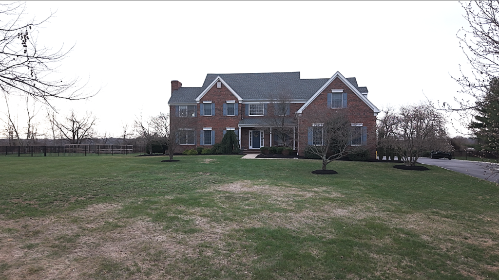 A residential yard with damage from the winter.