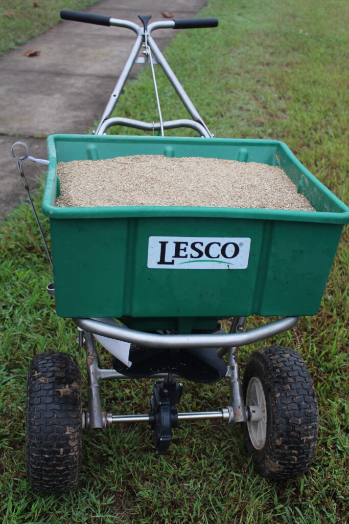 Picture of a spreader holding seed.